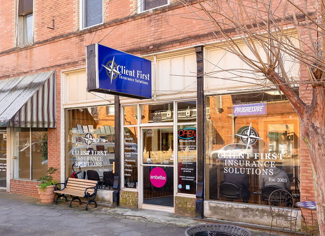 Contact - Exterior View of the Client First Insurance Solutions Office in a Brick Building on a Main Street